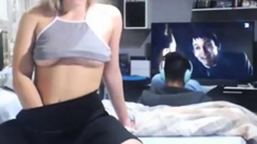 Teen masturbates on webcam with boyfriend in background